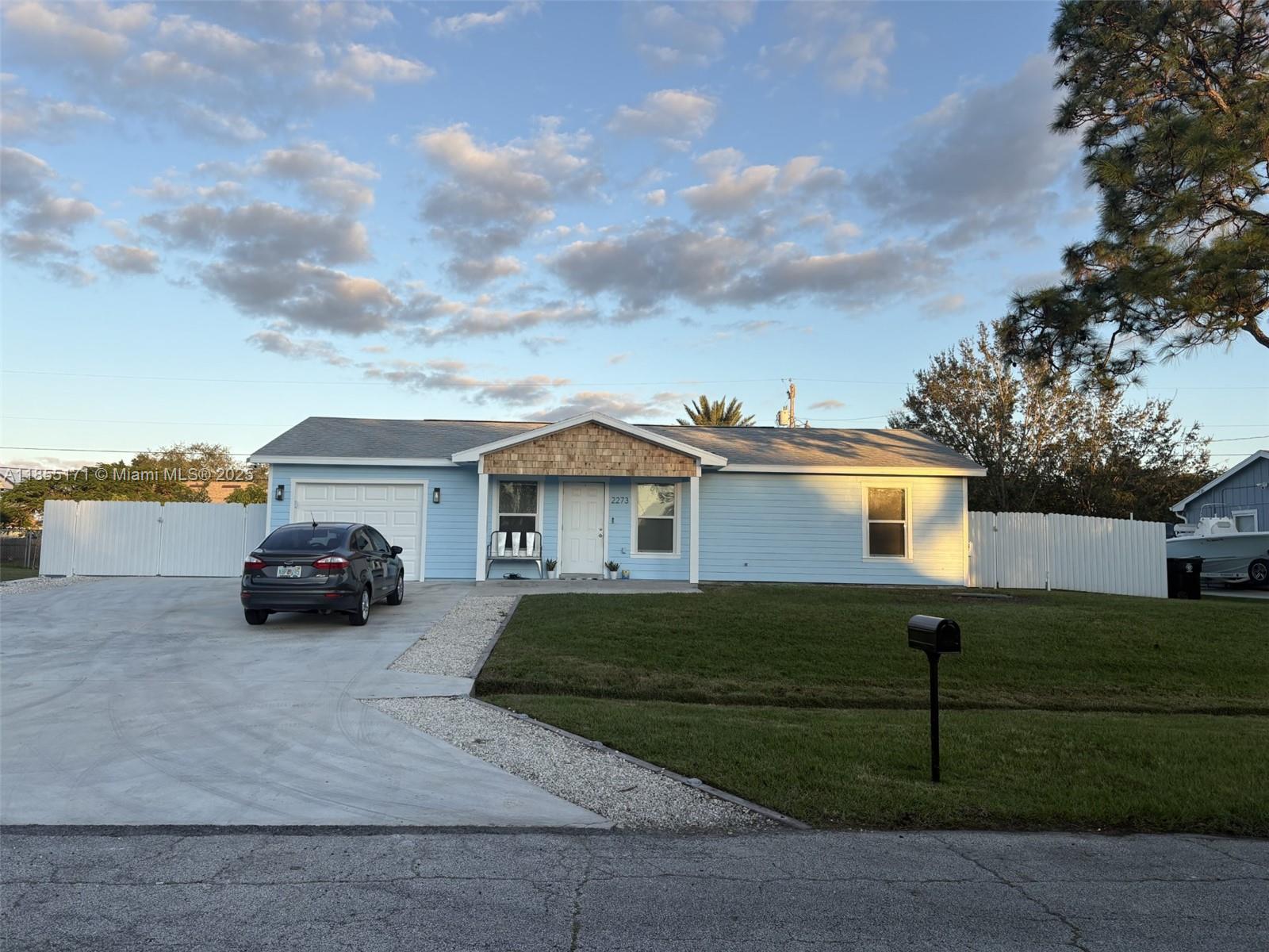 2273 Southwest Mt Vernon Street Port St. Lucie, FL 34953 - Photo 3 of 9 a view of a car parked in front of a house