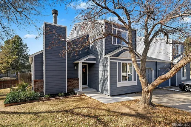 a view of a house with a tree
