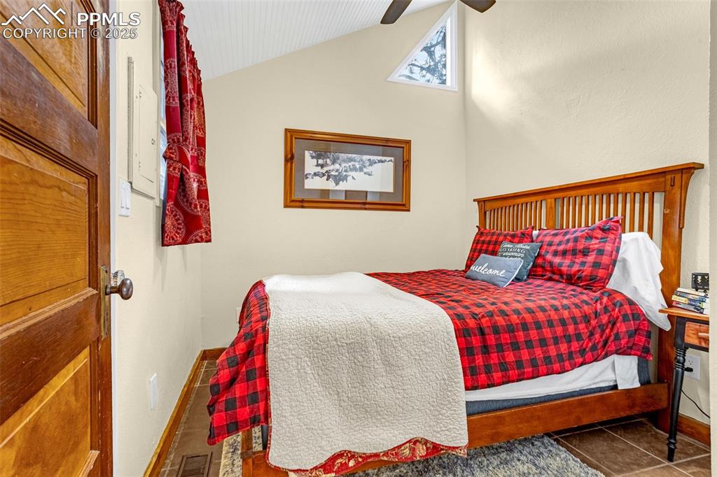 5870 Paona Road Cascade, CO 80809 - Photo 12 of 32 a bedroom with a bed and a painting on the wall