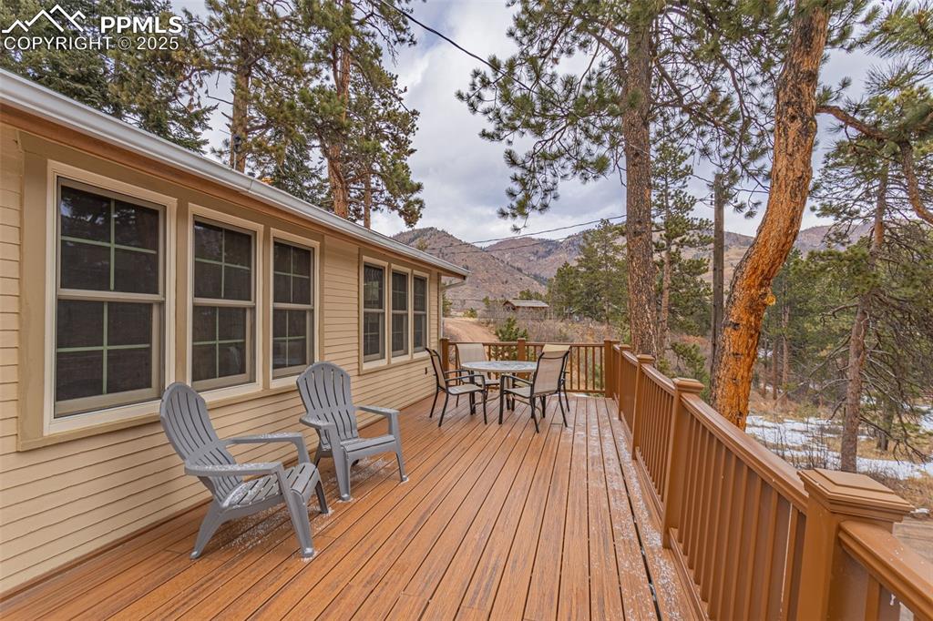 5870 Paona Road Cascade, CO 80809 - Photo 21 of 32 a view of a chair and table on the wooden deck