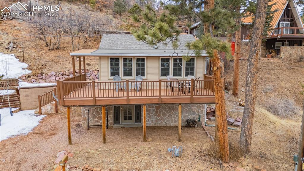 5870 Paona Road Cascade, CO 80809 - Photo 32 of 32 a table and chairs sitting in front of a house