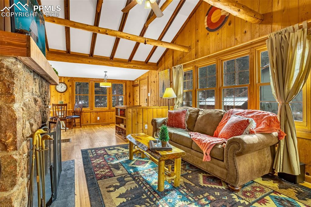 5870 Paona Road Cascade, CO 80809 - Photo 5 of 32 a living room with furniture and a floor to ceiling window