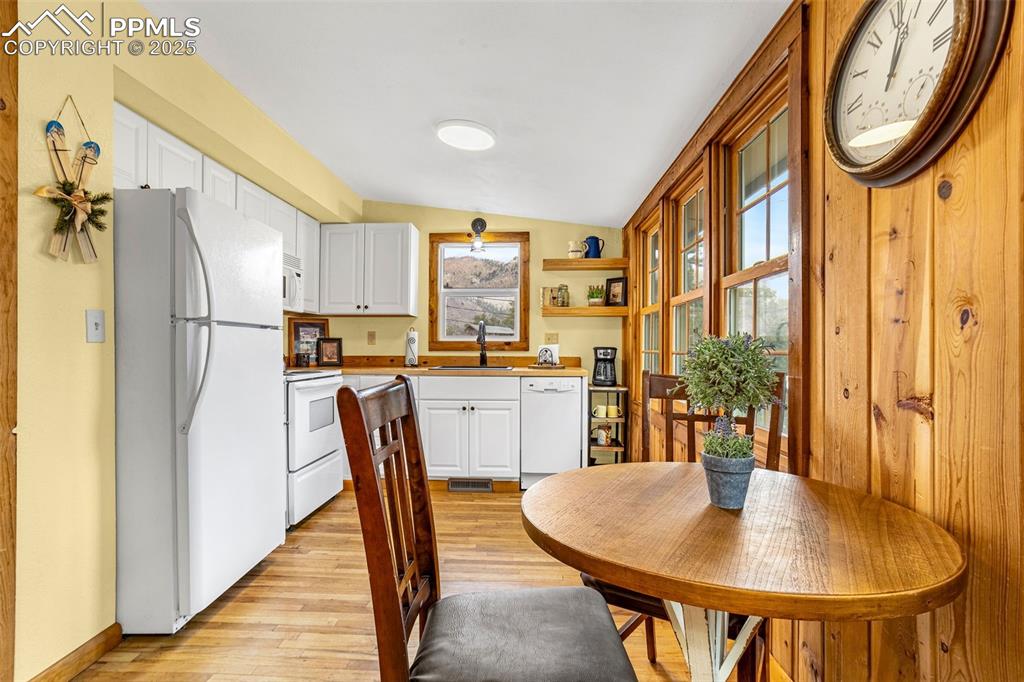 5870 Paona Road Cascade, CO 80809 - Photo 7 of 32 a kitchen with stainless steel appliances granite countertop a dining table chairs and a refrigerator