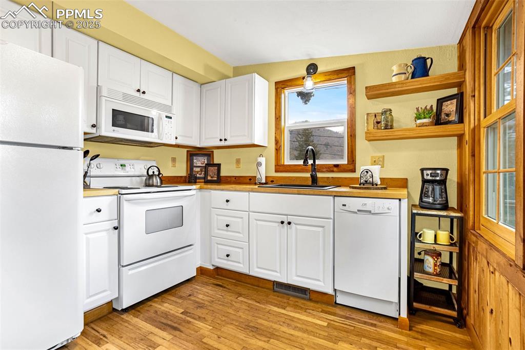 5870 Paona Road Cascade, CO 80809 - Photo 8 of 32 a kitchen with cabinets stainless steel appliances and a window