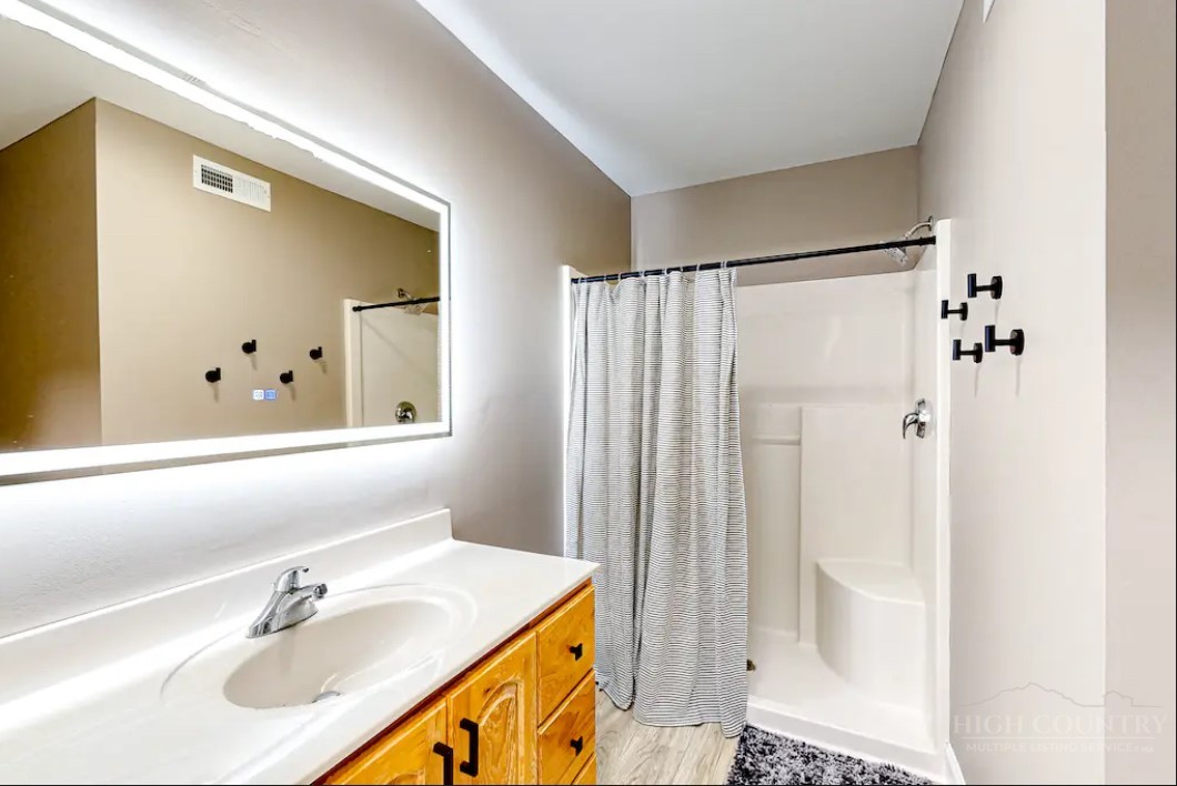 190 Still Lake Drive, Unit 321 Boone, NC 28607 - Photo 14 of 30 a bathroom with a sink and a mirror