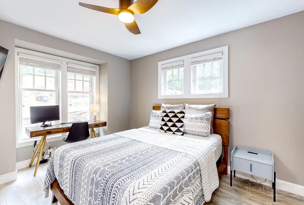 190 Still Lake Drive, Unit 321 Boone, NC 28607 - Photo 15 of 30 a bedroom with a bed and wooden floor