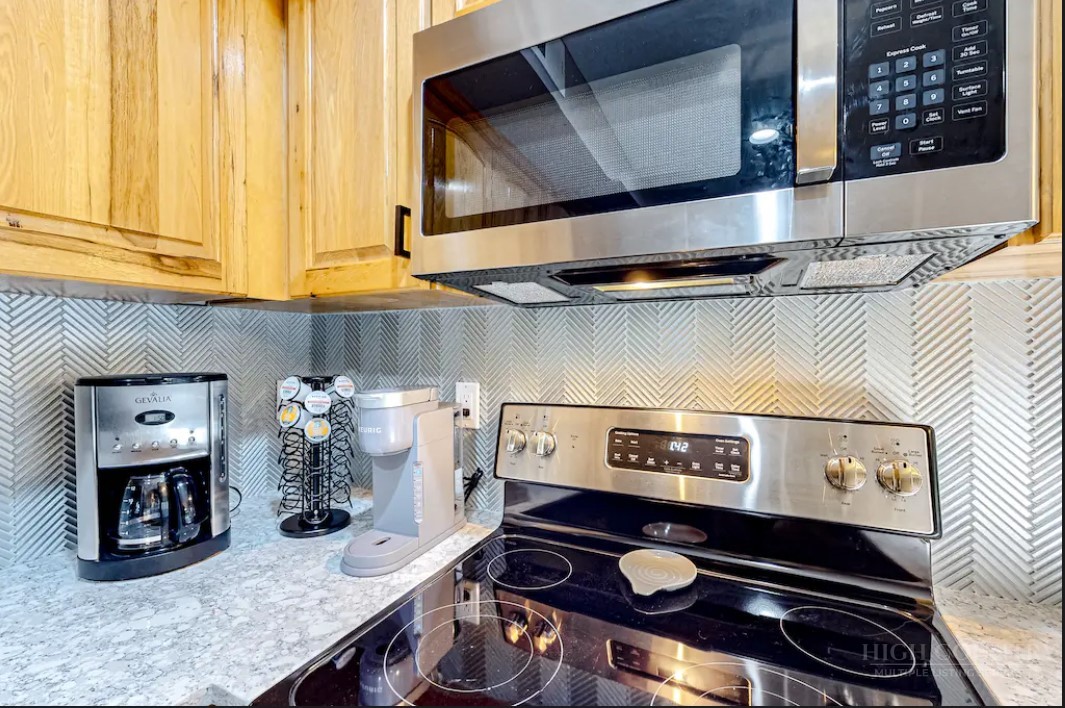 190 Still Lake Drive, Unit 321 Boone, NC 28607 - Photo 9 of 30 a kitchen with a stove and cabinets