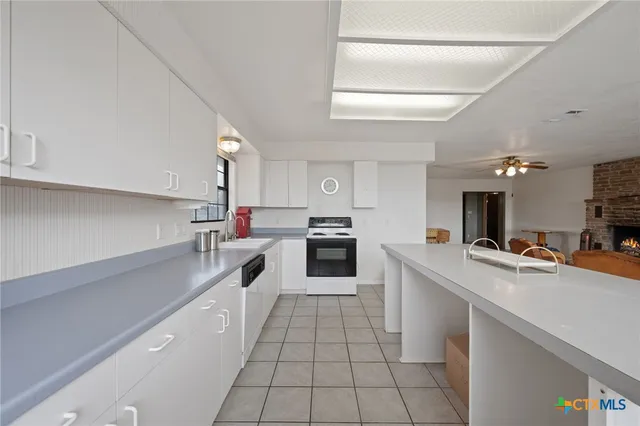 a kitchen with stainless steel appliances a stove sink and cabinets
