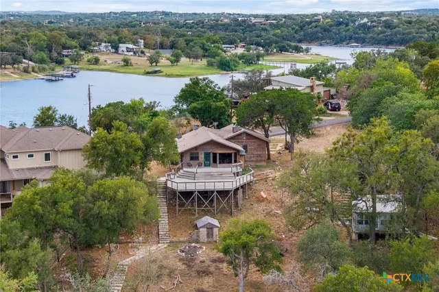 an aerial view of a houses with ocean view