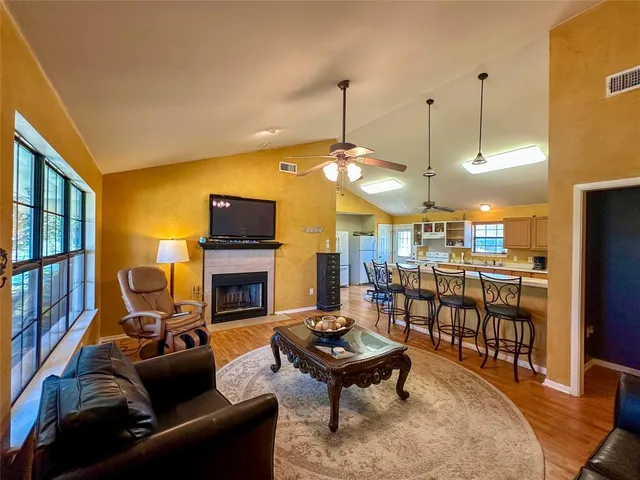 a living room with fireplace furniture and a flat screen tv