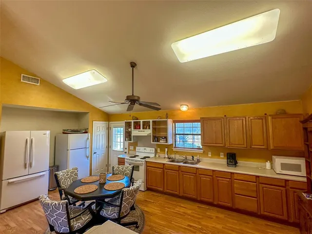 a kitchen with a sink cabinets and wooden floor