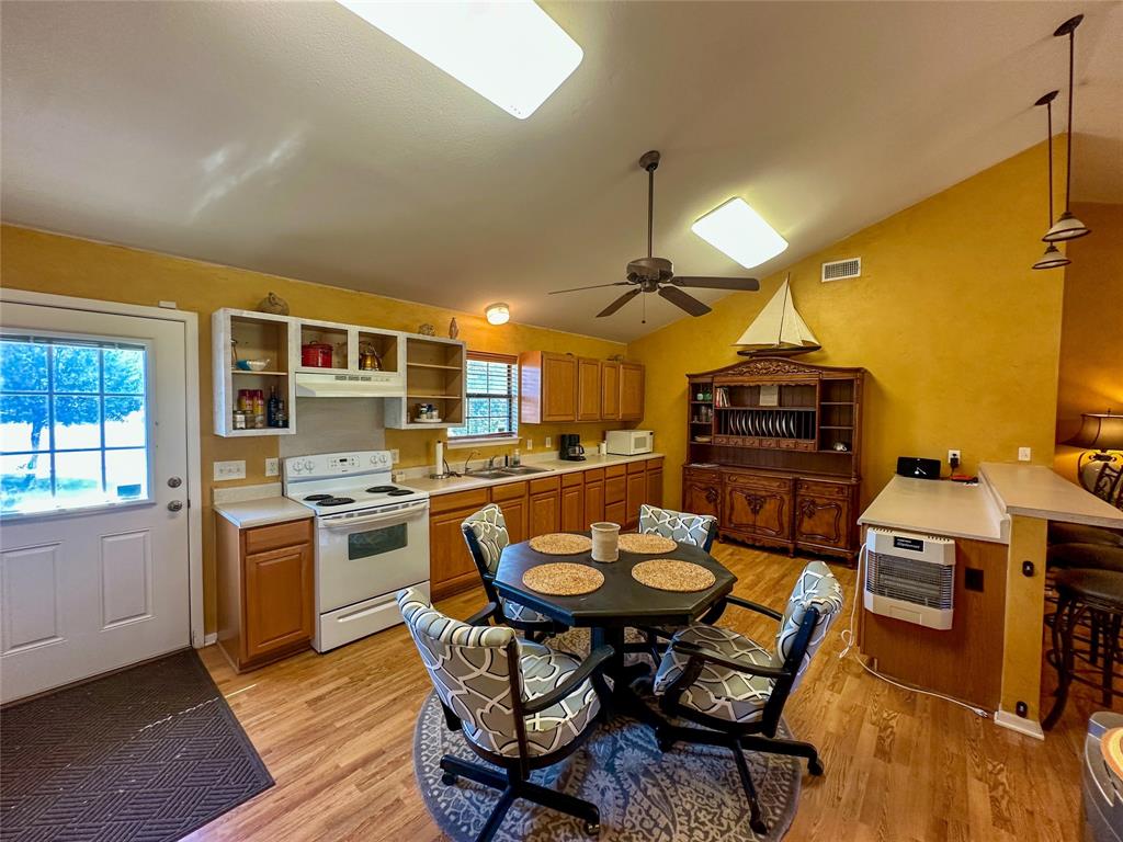 3500 Hog Bend, Unit 135 Graford, TX 76449 - Photo 16 of 34 a view of a dining room with furniture and a kitchen