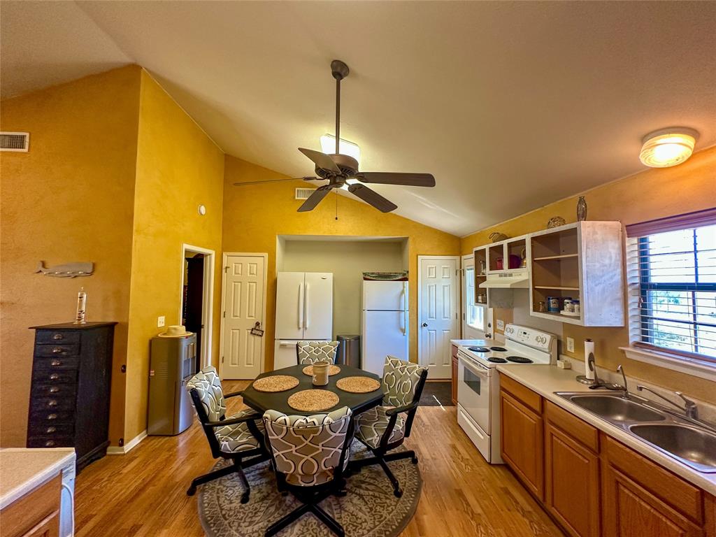 3500 Hog Bend, Unit 135 Graford, TX 76449 - Photo 17 of 34 a dining room with stainless steel appliances granite countertop furniture and a kitchen view