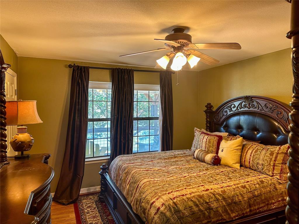 3500 Hog Bend, Unit 135 Graford, TX 76449 - Photo 18 of 34 a bedroom with a bed and a chandelier