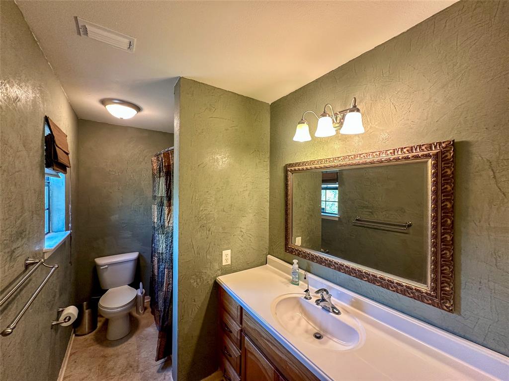3500 Hog Bend, Unit 135 Graford, TX 76449 - Photo 20 of 34 a bathroom with a sink a toilet and shower