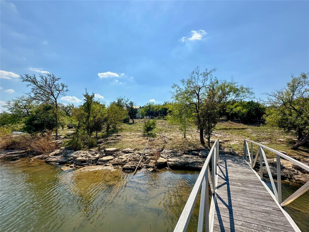 3500 Hog Bend, Unit 135 Graford, TX 76449 - Photo 31 of 34 a view of a lake with a deck