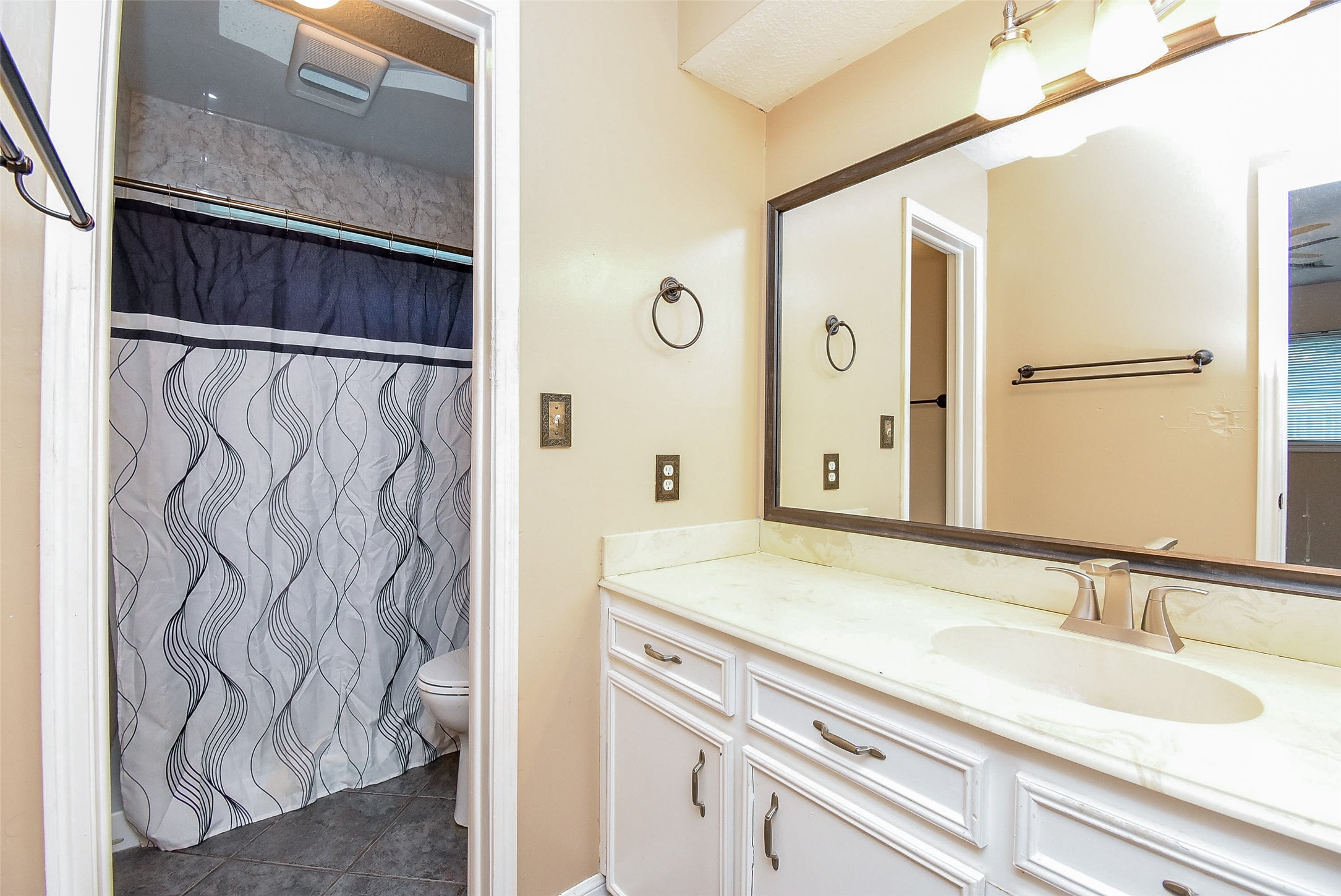 7814 Friars Ct Lane Spring, TX 77379 - Photo 13 of 17 a bathroom with a sink and a mirror
