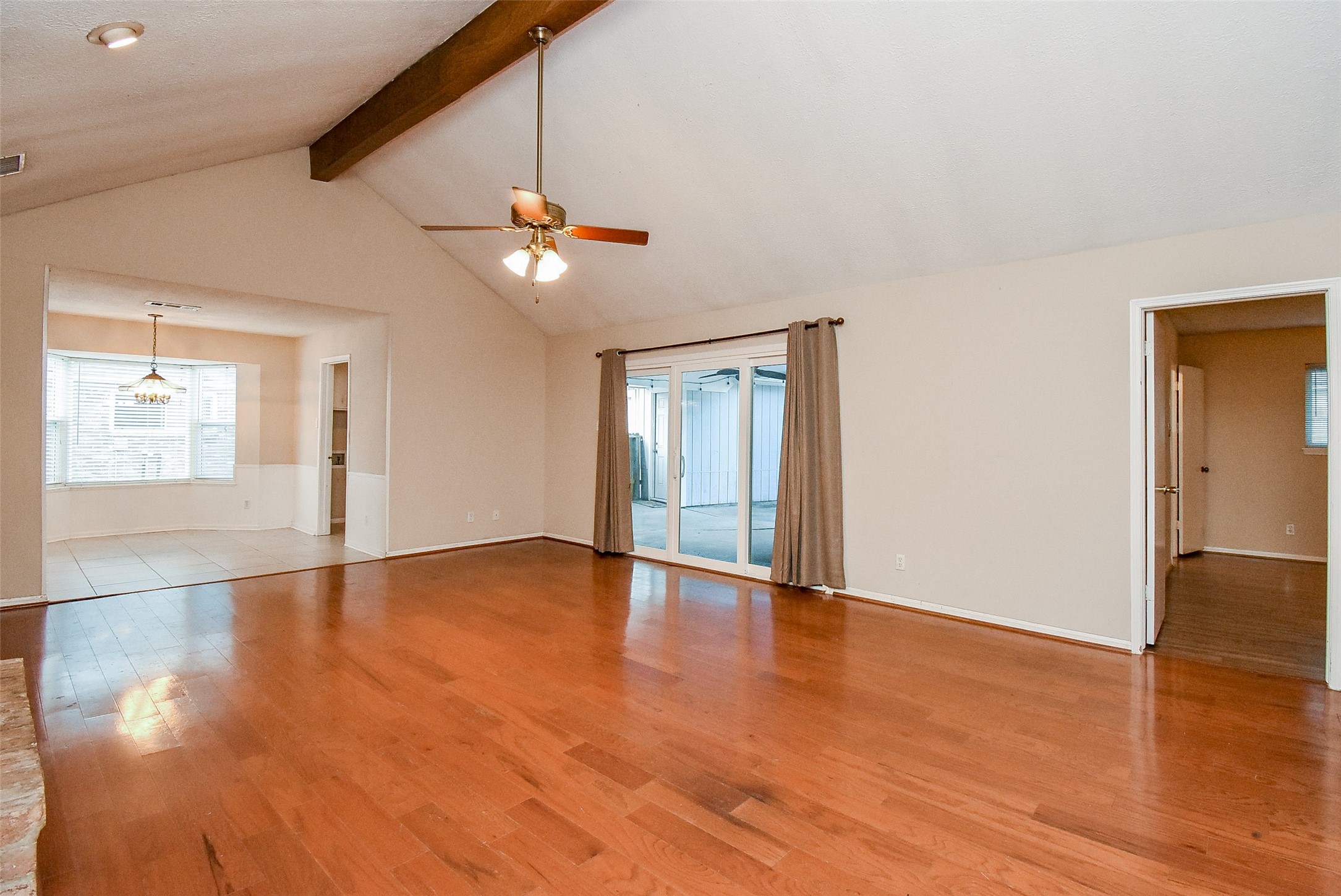 7814 Friars Ct Lane Spring, TX 77379 - Photo 4 of 17 a view of an empty room with window and wooden floor