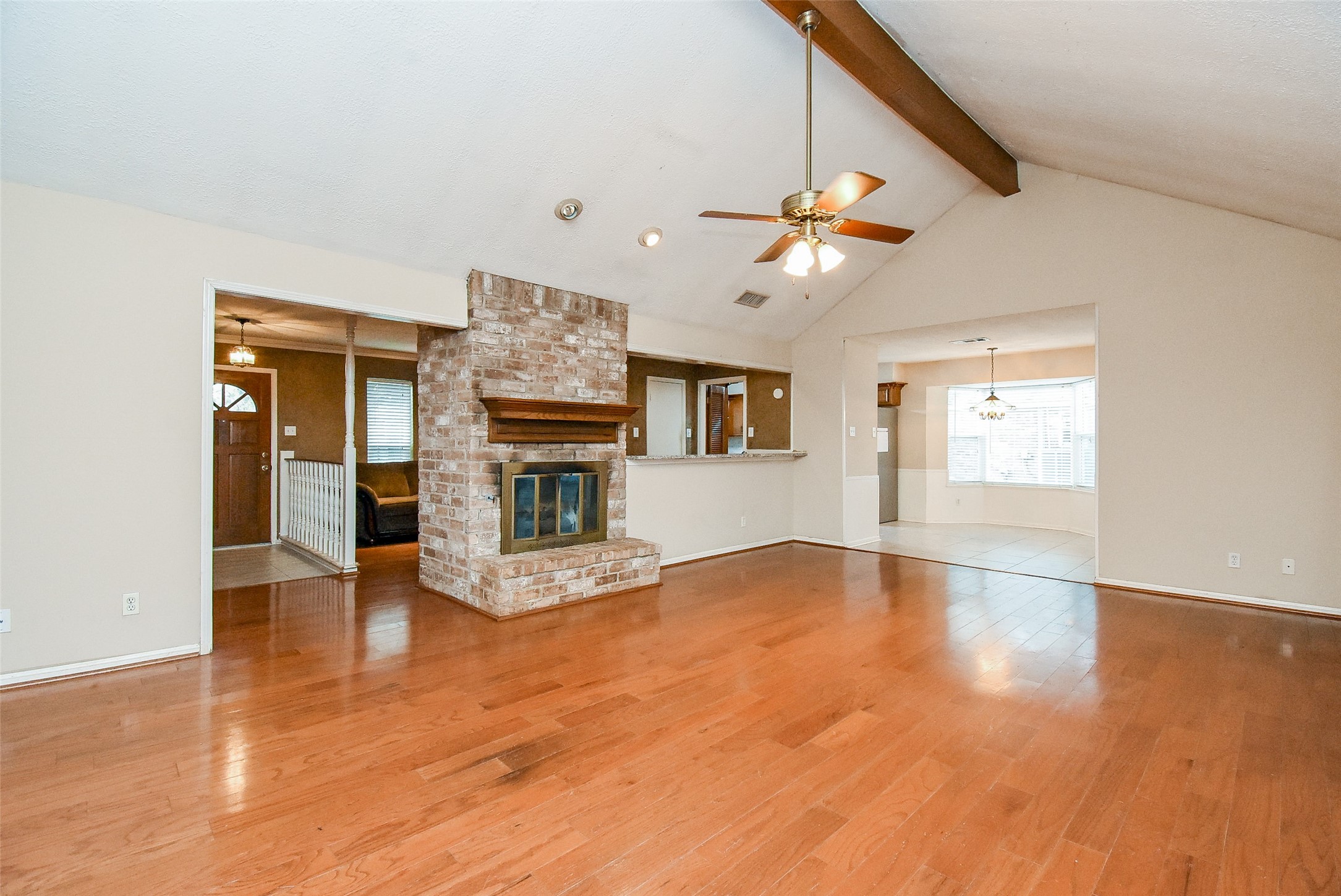 7814 Friars Ct Lane Spring, TX 77379 - Photo 5 of 17 a view of an empty room with chandelier fan and wooden floor