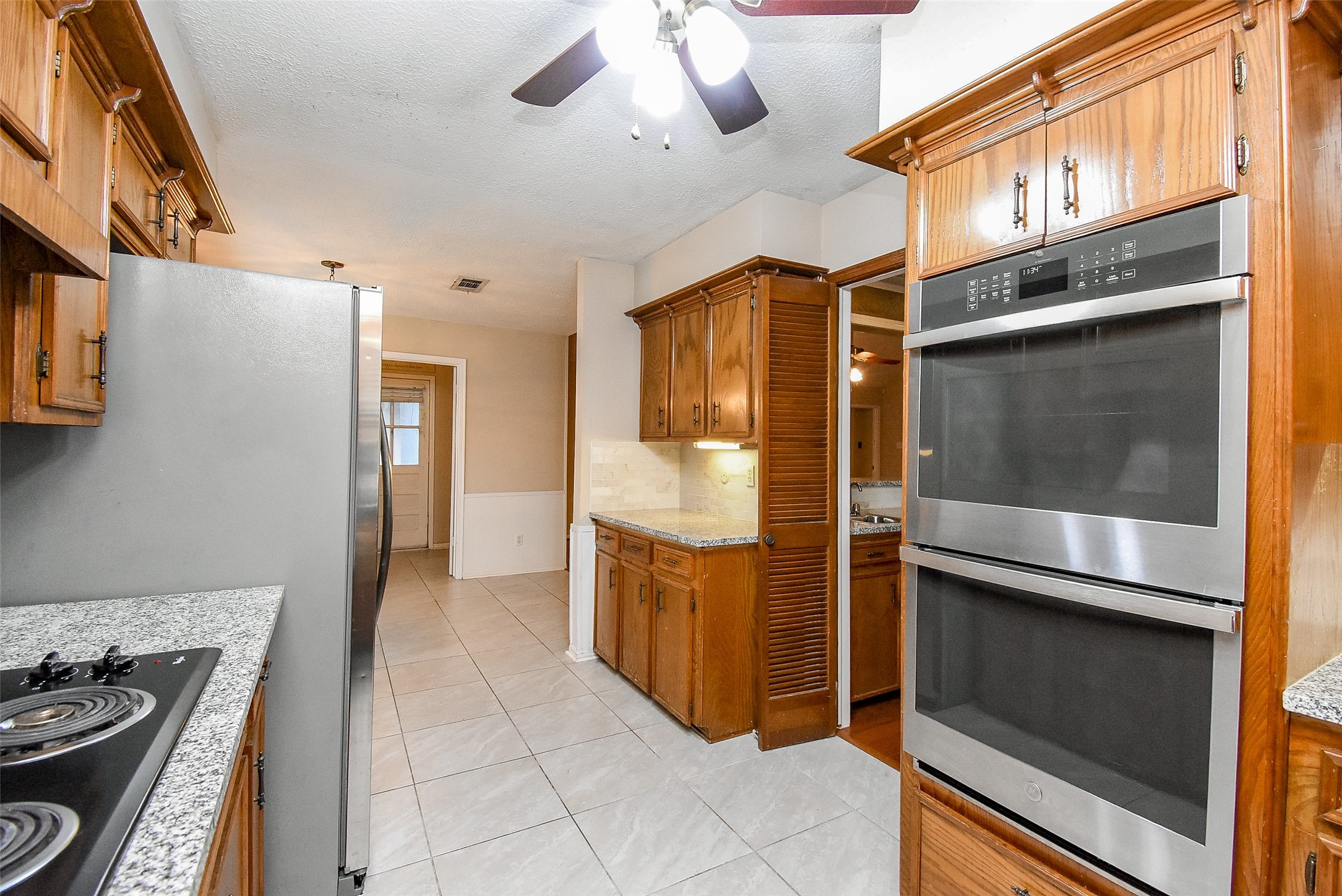 7814 Friars Ct Lane Spring, TX 77379 - Photo 9 of 17 a kitchen with a refrigerator and a stove