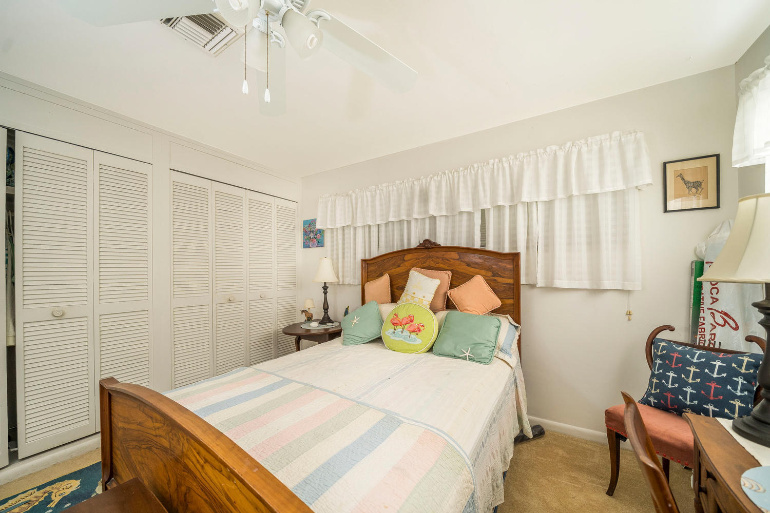 100 River Drive Tequesta, FL 33469 - Photo 11 of 54 a bedroom with a bed and chair