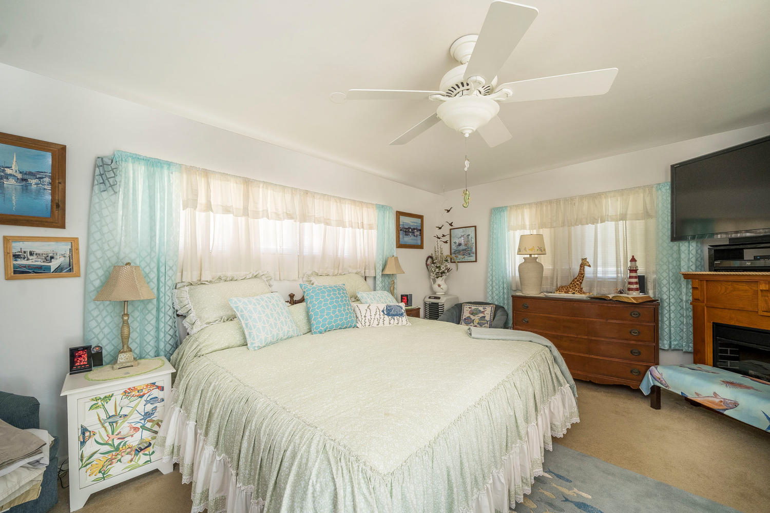 100 River Drive Tequesta, FL 33469 - Photo 13 of 54 a bedroom with a bed and a flat tv screen on dresser