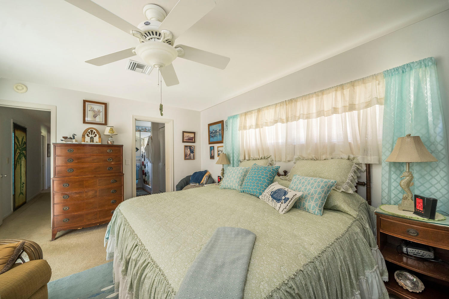 100 River Drive Tequesta, FL 33469 - Photo 24 of 54 a bedroom with a bed and a chandelier