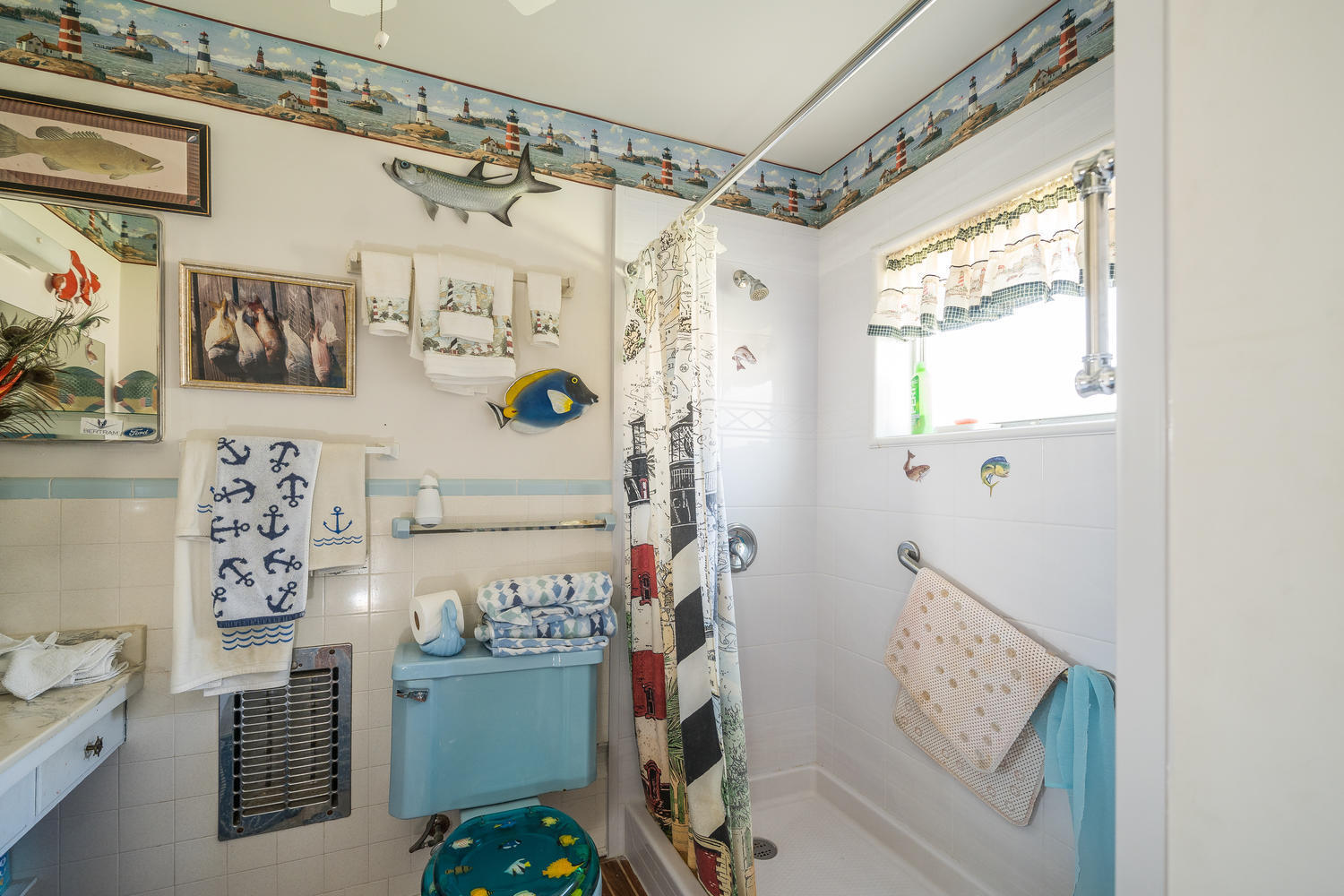 100 River Drive Tequesta, FL 33469 - Photo 26 of 54 a bathroom with a refrigerator and a shower curtain