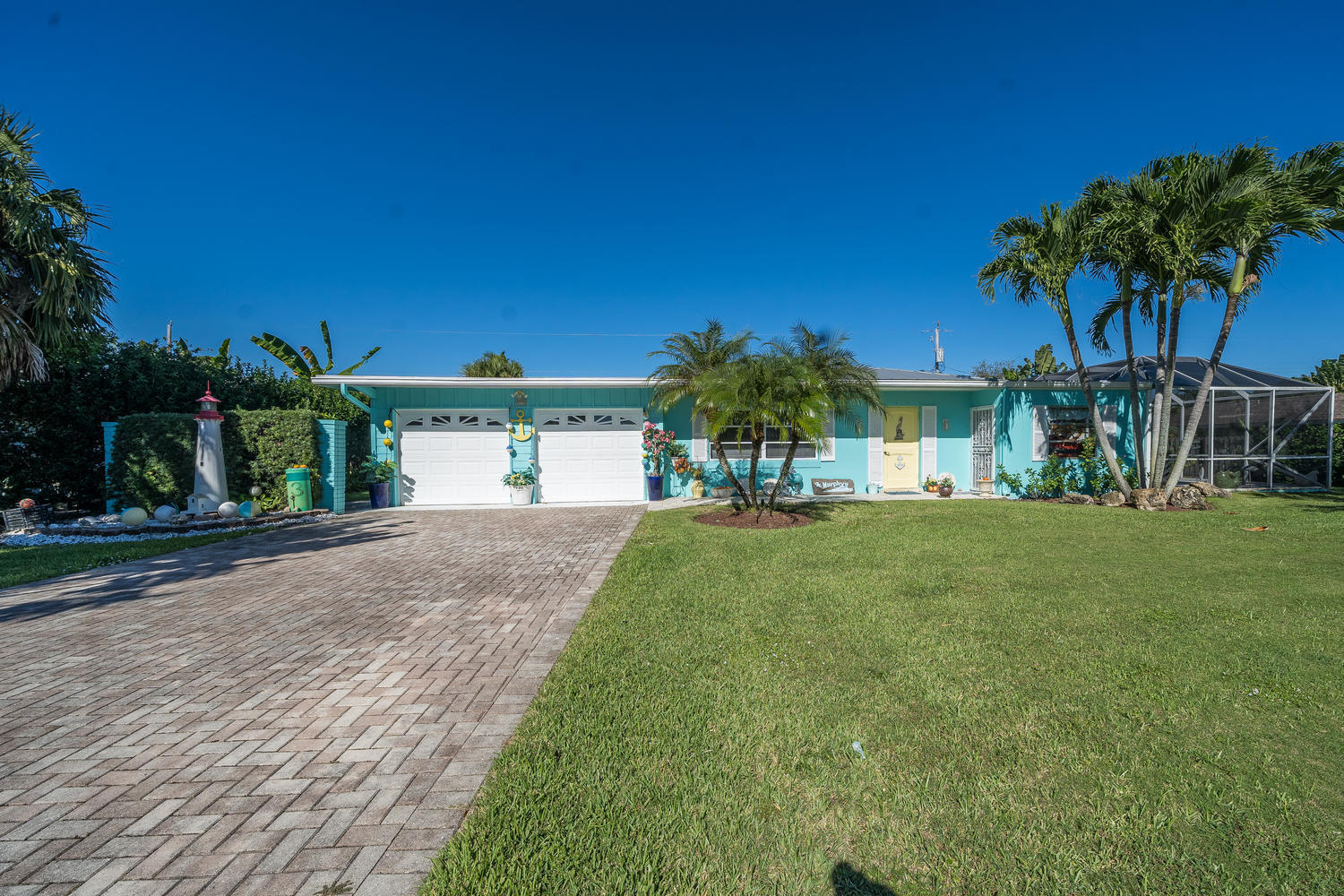 100 River Drive Tequesta, FL 33469 - Photo 29 of 54 a front view of a house with garden