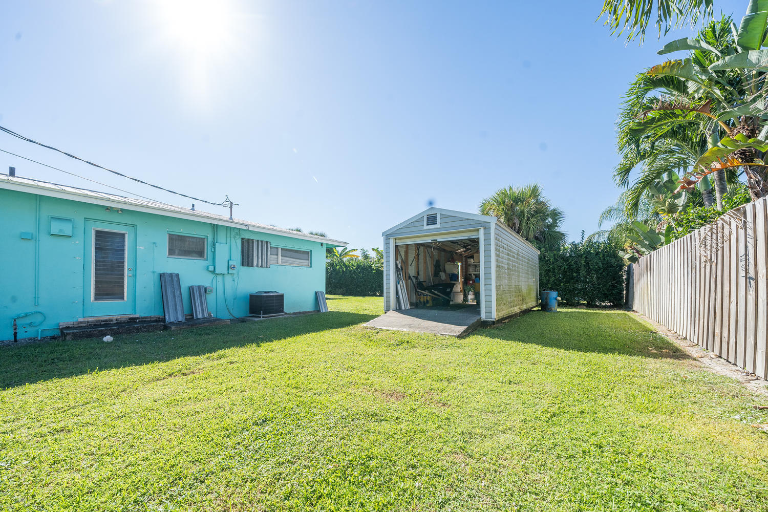 100 River Drive Tequesta, FL 33469 - Photo 31 of 54 a view of a house with a yard and garage