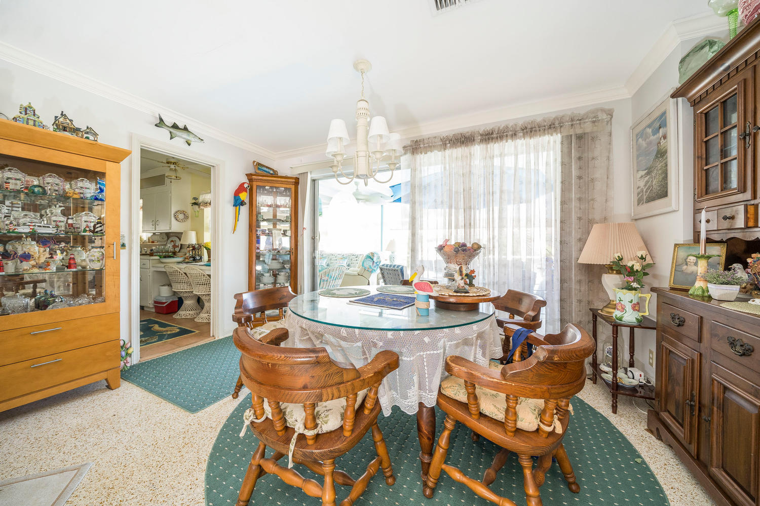 100 River Drive Tequesta, FL 33469 - Photo 4 of 54 a dining room with furniture a chandelier and window
