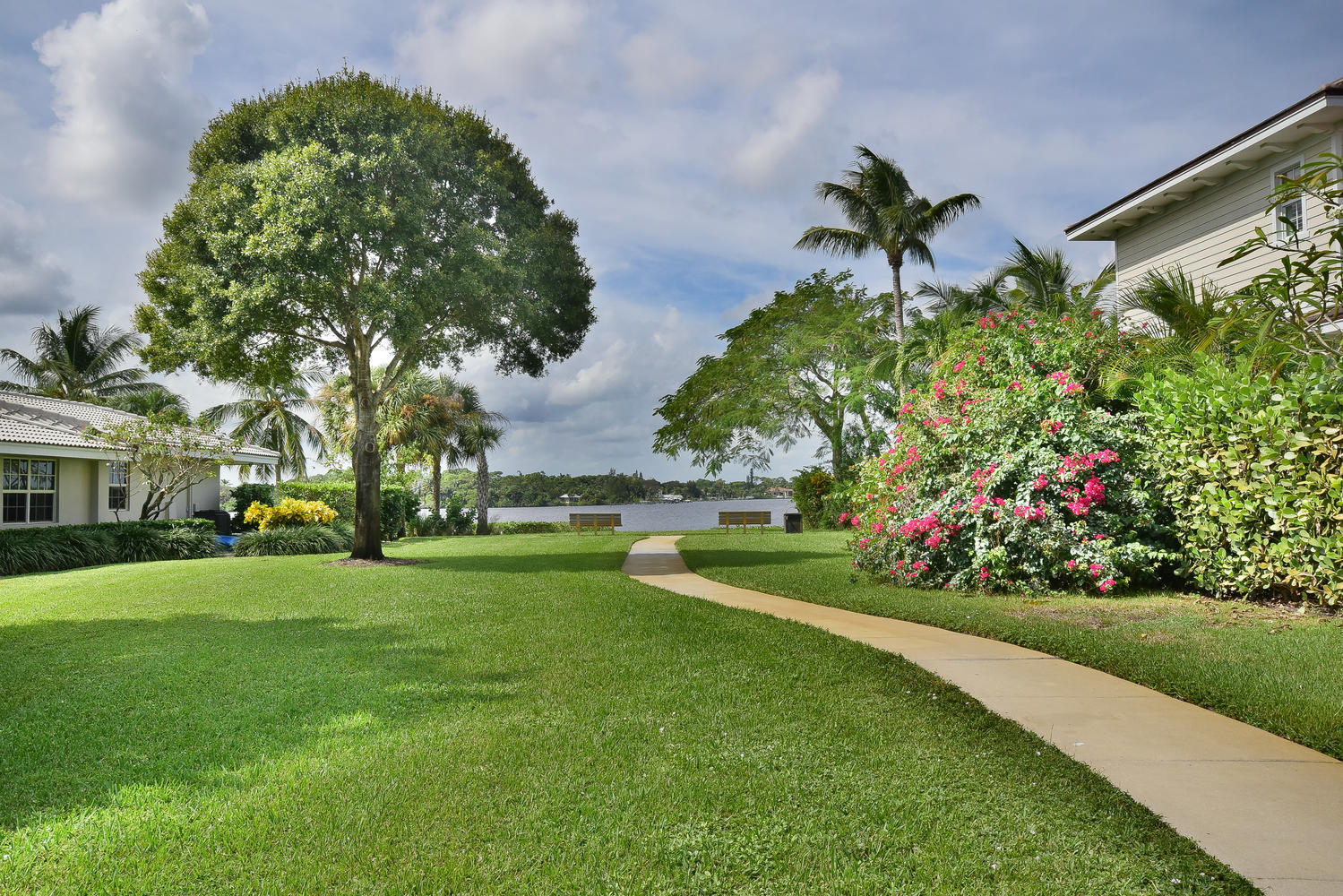 100 River Drive Tequesta, FL 33469 - Photo 47 of 54 a view of a house with a big yard and potted plants