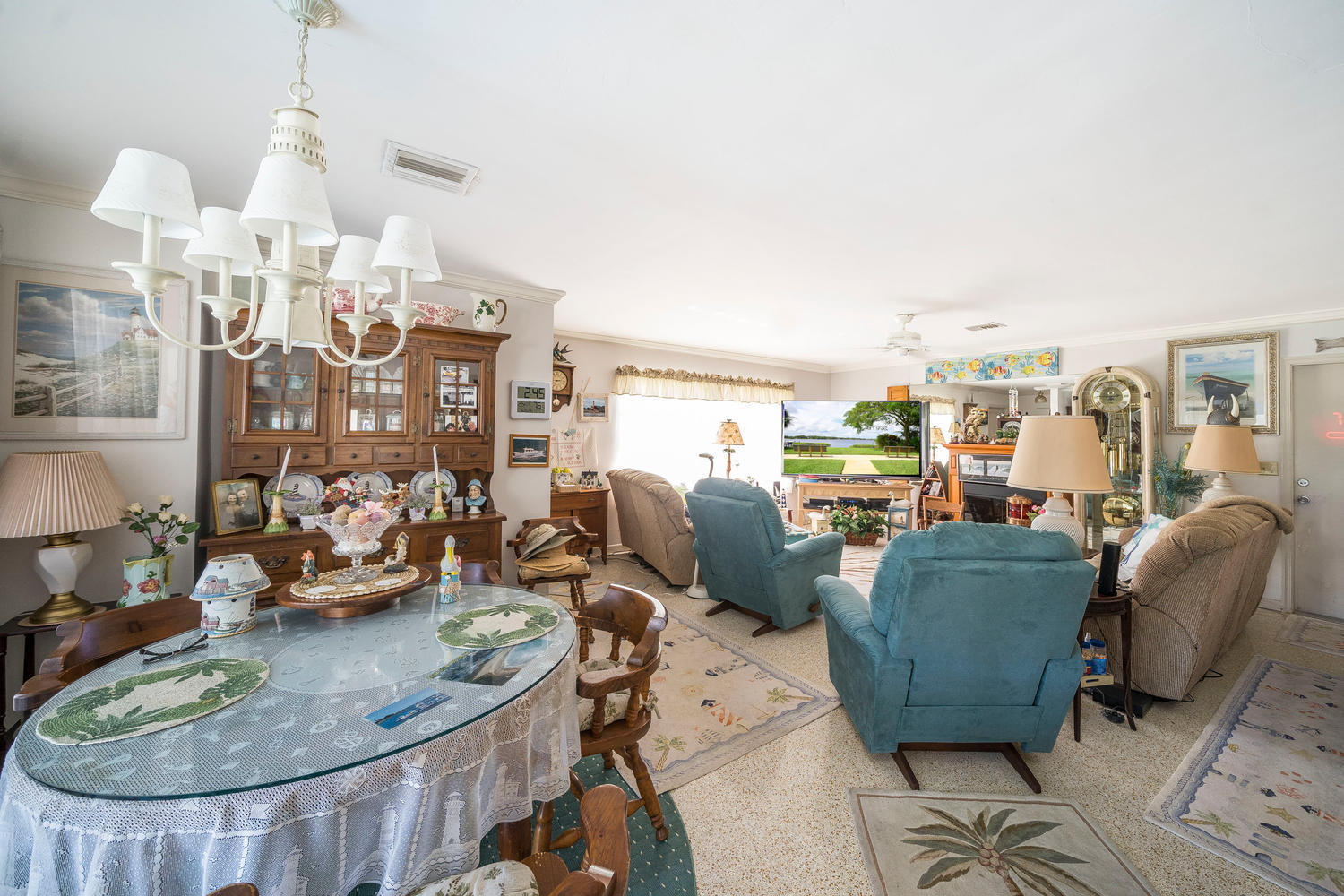 100 River Drive Tequesta, FL 33469 - Photo 5 of 54 a living room with lots of furniture and a chandelier