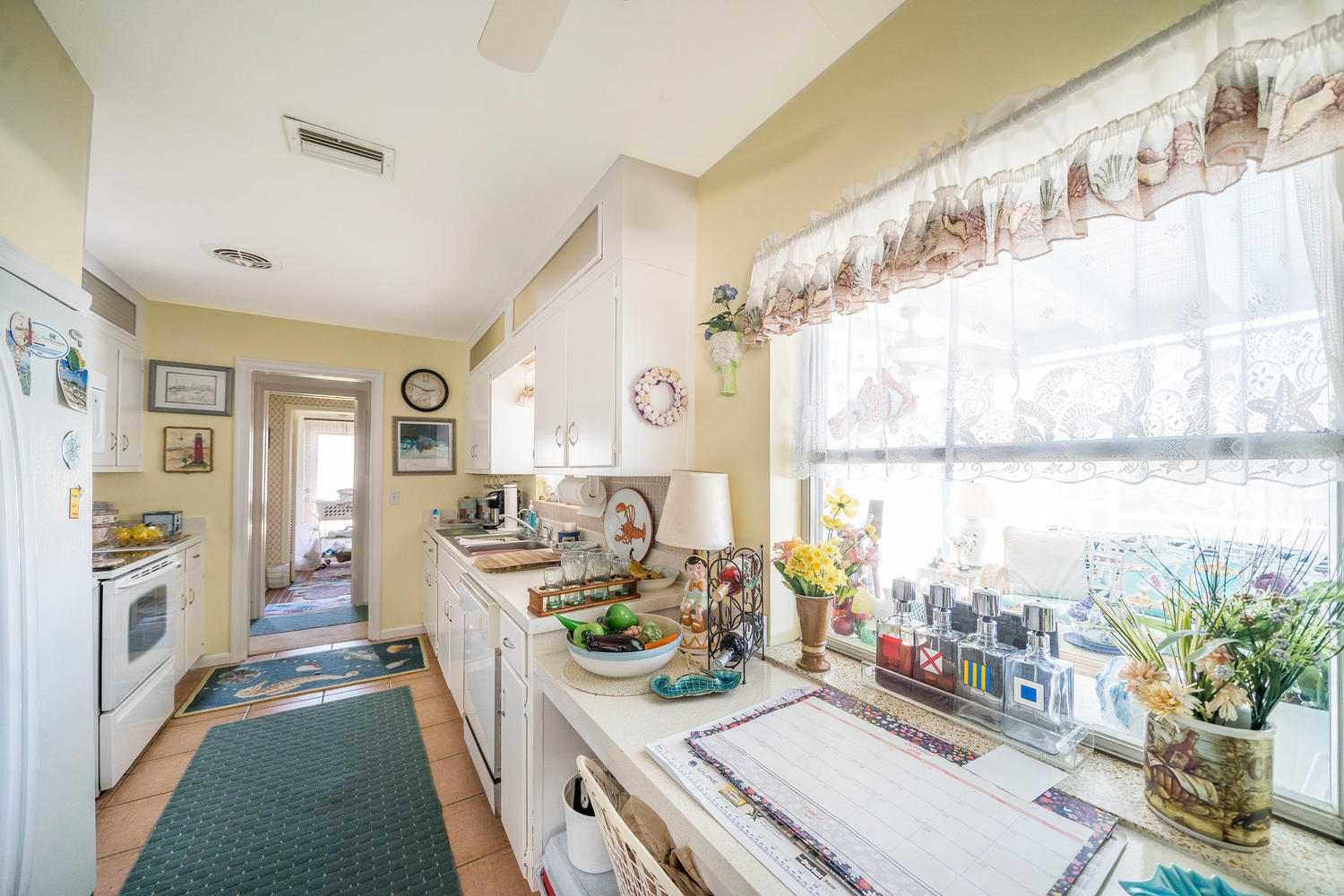 100 River Drive Tequesta, FL 33469 - Photo 6 of 54 a kitchen filled with a large window appliances and a counter top space