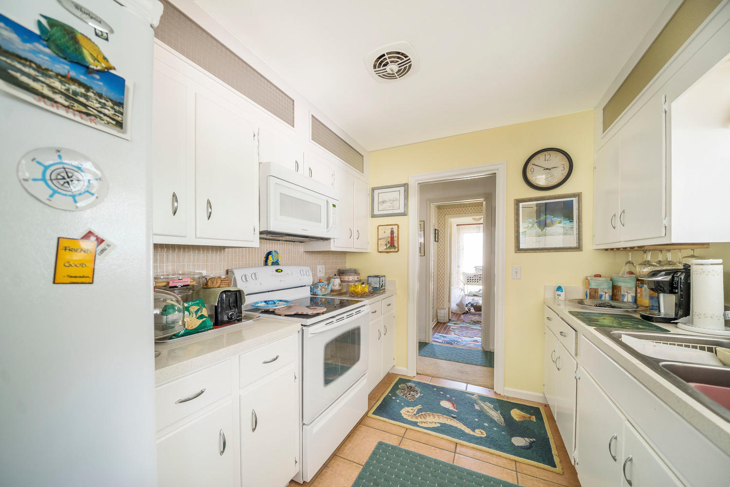 100 River Drive Tequesta, FL 33469 - Photo 8 of 54 a kitchen with a sink and a stove top oven