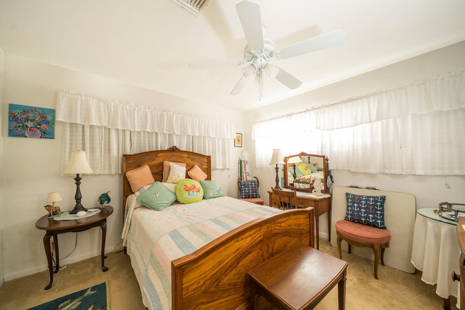 100 River Drive Tequesta, FL 33469 - Photo 10 of 54 a bedroom with a bed and a chandelier