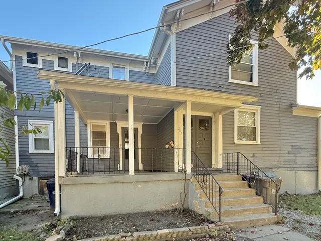 front view of a house with a bench