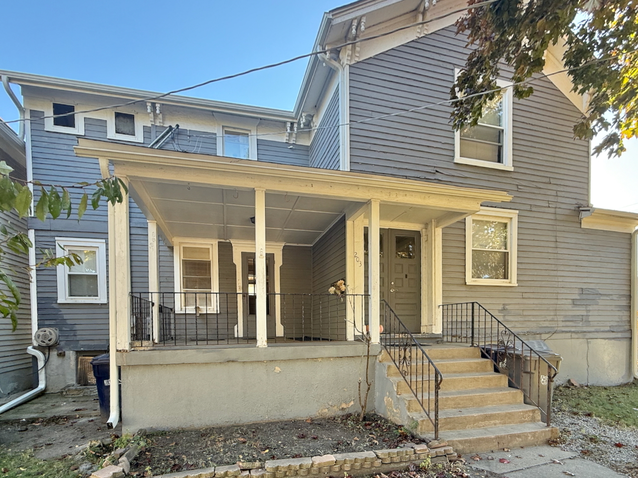 203 Symphony Way, Unit 203A Elgin, IL 60120 - Photo 17 of 18 front view of a house with a bench