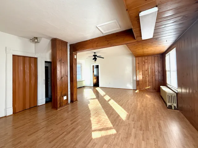 a view of a hallway view with wooden floor and staircase