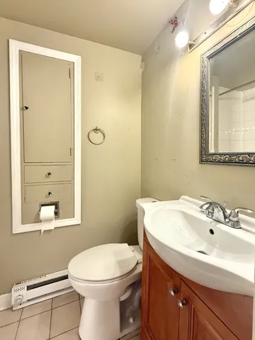 a bathroom with a sink a toilet and mirror