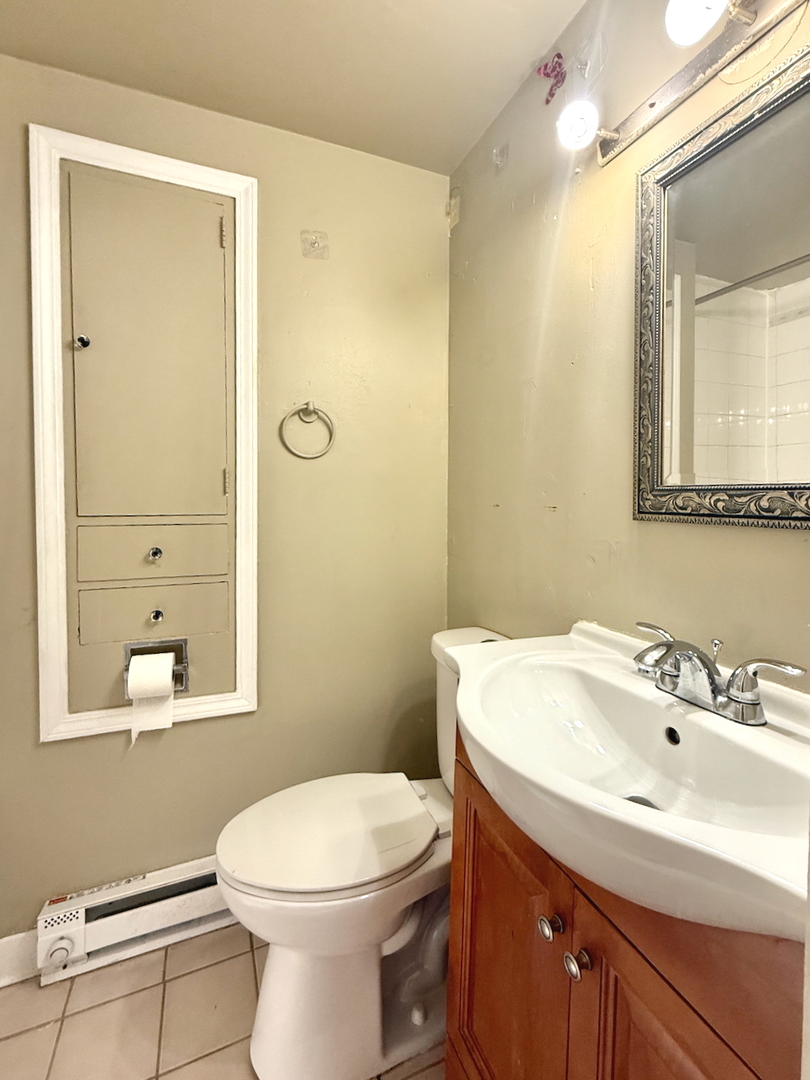 203 Symphony Way, Unit 203A Elgin, IL 60120 - Photo 10 of 18 a bathroom with a sink a toilet and mirror