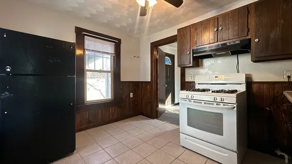 a kitchen with stainless steel appliances granite countertop a stove a refrigerator and a microwave
