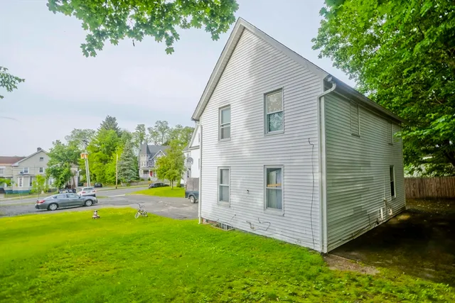 a view of a backyard with plants and a patio