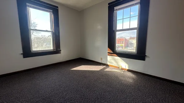 an empty room with a empty space and windows