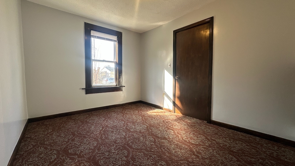 295 Main Street Springfield, MA 01151 - Photo 6 of 9 an empty room with windows and closet
