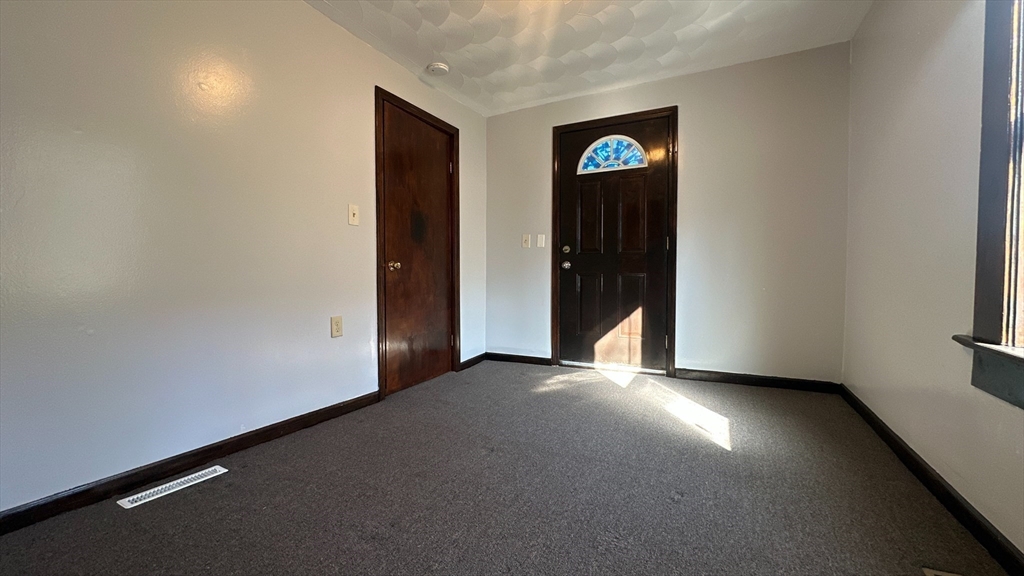 295 Main Street Springfield, MA 01151 - Photo 7 of 9 an empty room with closet and windows