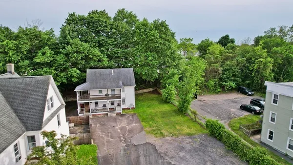 an aerial view of a house with garden space and street view