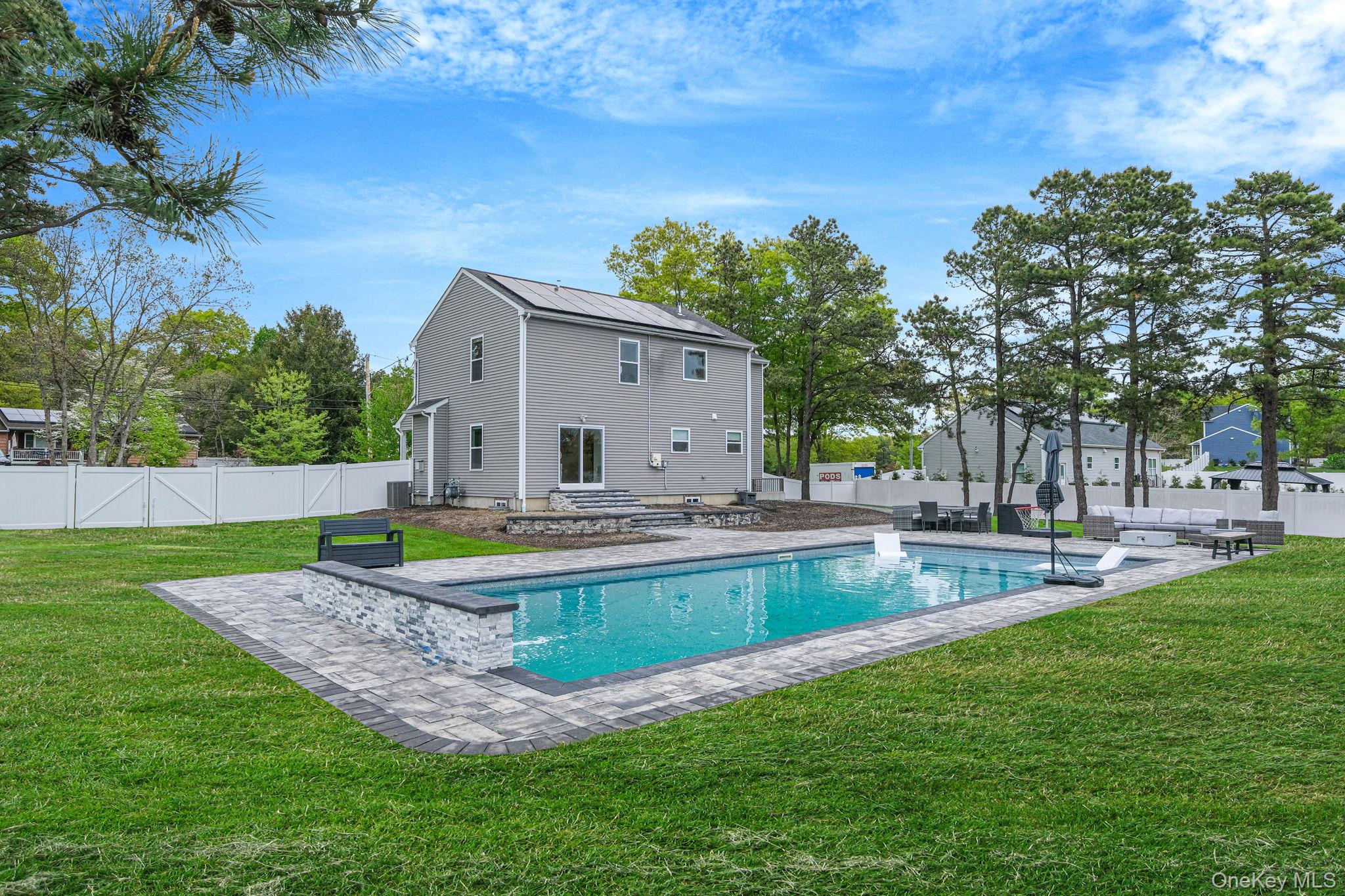 86 Country Road Medford, NY 11763 - Photo 7 of 47 .52 acres with 44’ x 20’ gas-heated Jandy TruGuard mineral in-ground pool with a 10’ sundeck, lounge area, and gorgeous waterfall feature