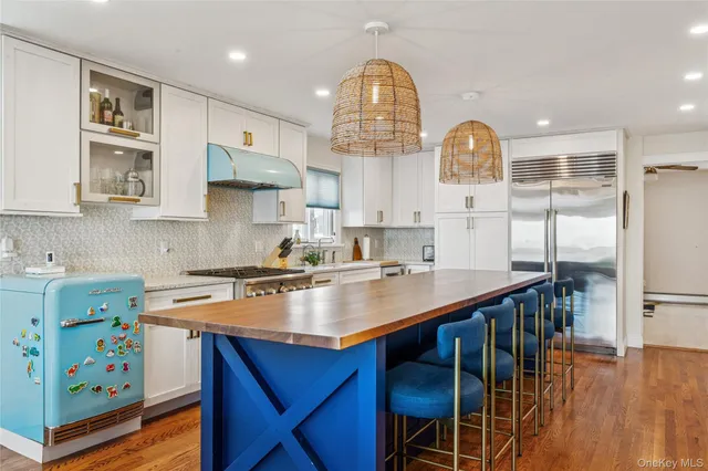 a living room with fireplace furniture and a large window