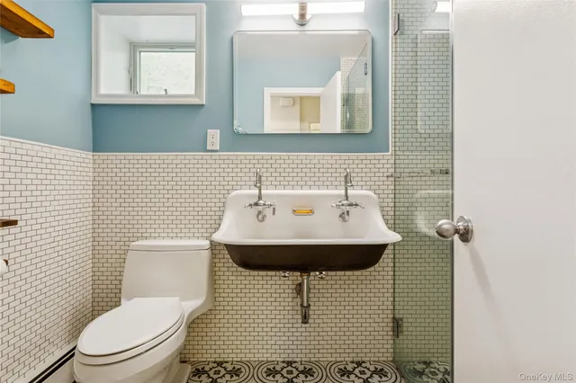 a kitchen with stainless steel appliances granite countertop a stove a sink dishwasher and a dining table with wooden floor